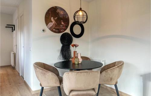 a dining room with a black table and chairs at Awesome Home In Heinkenszand With Wifi in Heinkensand