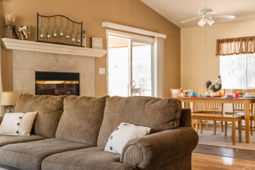 a living room with a couch and a dining room at Lazy Squirrel - Cozy Family House with Full Game Room in Kernville