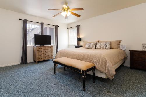a bedroom with a bed and a ceiling fan at Lazy Squirrel - Cozy Family House with Full Game Room in Kernville