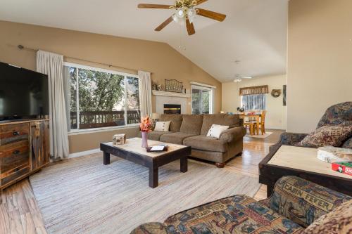 a living room with a couch and a tv at Lazy Squirrel - Cozy Family House with Full Game Room in Kernville
