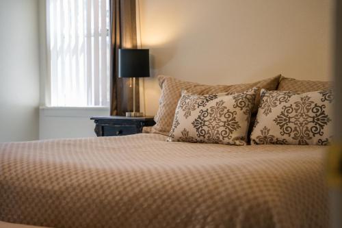 a bedroom with a bed with pillows and a window at Lazy Squirrel - Cozy Family House with Full Game Room in Kernville