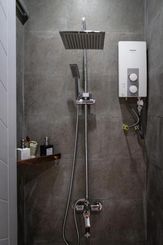 a shower in a bathroom with a shower at Kampot Tropical Village in Kampot