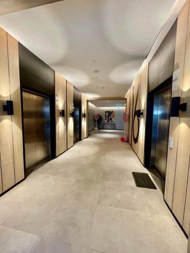 an empty hallway in a building with doors and a hallwayngth at Aeon Tower 2627 in Davao City