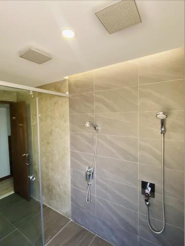 a bathroom with a shower with a glass door at Bill Tourist Inn in El Nido