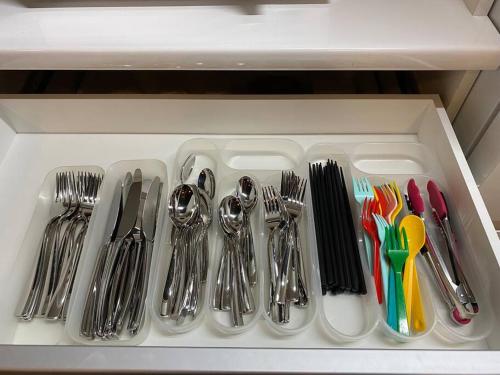 a drawer filled with silver utensils and forks and spoons at sauna×star×sea　Highland Panorama Ocean View in Shima