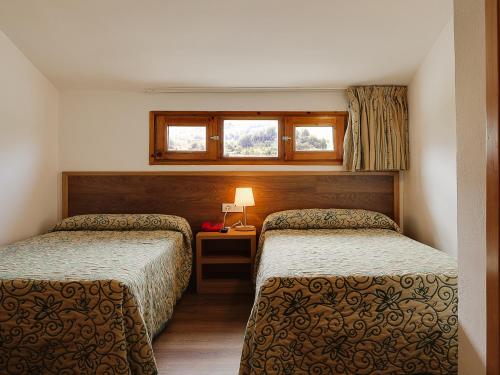 Un pat sau paturi într-o cameră la Evenia Monte Alba
