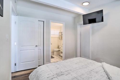a bedroom with a bed and a television on the wall at Less Than 1 Mi to El Paseo Cottage Oasis with Fire Pit in Palm Desert