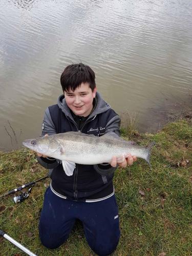 a young boy holding a fish in his hand at Kollerhof in Neunburg vorm Wald