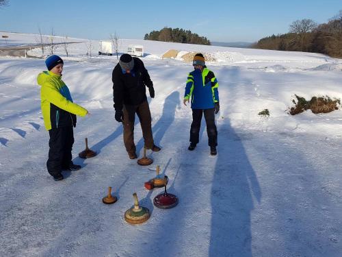 a group of people playing with objects in the snow at Kollerhof in Neunburg vorm Wald