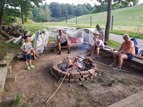 a group of people sitting around a fire pit at Kollerhof in Neunburg vorm Wald