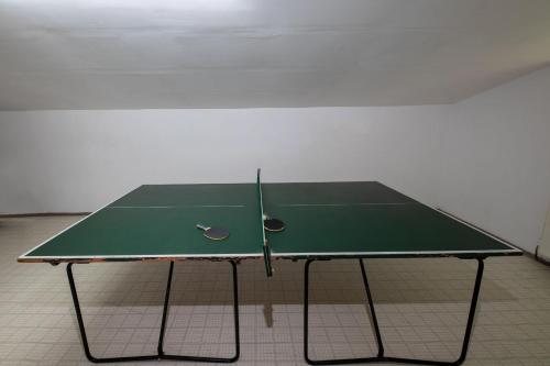 a ping pong table with a tennis racket on it at Chalet Gletschermoos - Summer Card included in Zell am See