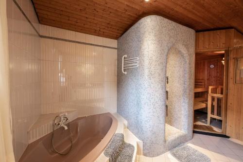 a bath tub with two chairs in a bathroom at Chalet Gletschermoos in Zell am See