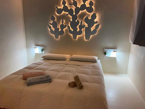 um quarto com uma grande cama branca com dois sapatos em Casa Mediterranea con JACUZZI ,OSTUNI , vista Mare Torre Guaceto em Specchiolla