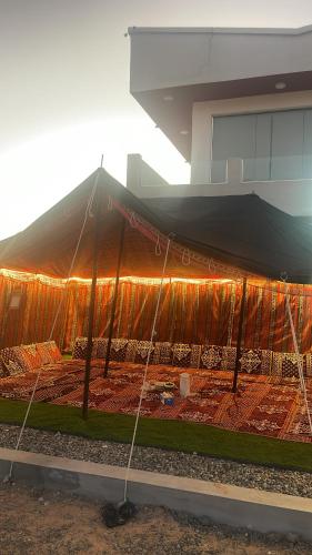 a large tent with lights on the side of a building at Home X4 in Al Wāşil