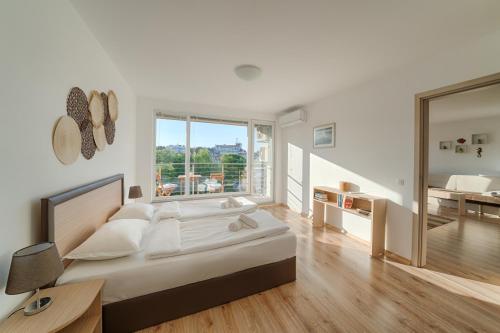 a bedroom with a bed and a desk and a mirror at Moana Fishermen Apartment in Ahtopol