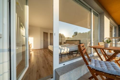 a room with a table and a glass door at Moana Fishermen Apartment in Ahtopol