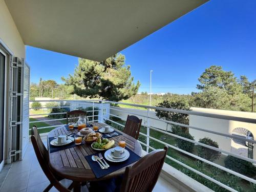 a dining table on the balcony of a house at Alvor Paradise With Pool by Homing in Alvor