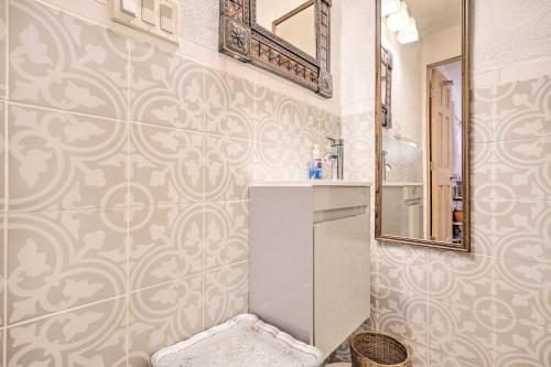 a bathroom with a sink and a mirror at Quirky Santa Cruz Studio with Shared Hot Tub! in Santa Cruz