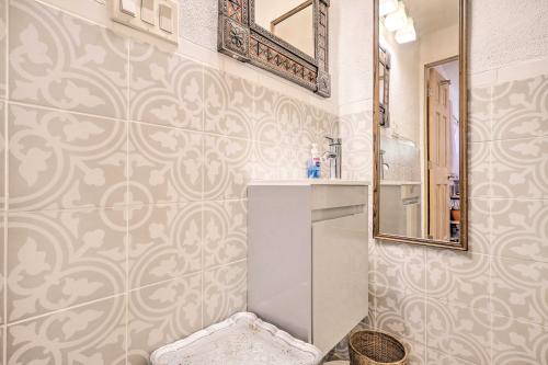 a bathroom with a sink and a mirror at Quirky Santa Cruz Studio with Shared Courtyard! in Santa Cruz