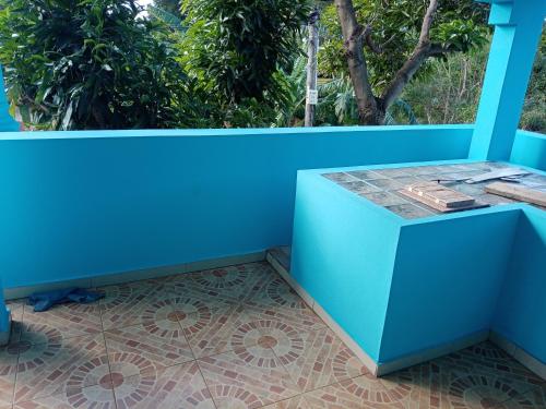 a blue wall with a table on a balcony at My house in Port Louis