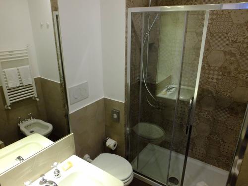 a bathroom with a shower and a toilet and a sink at Zefiro Home in Rome