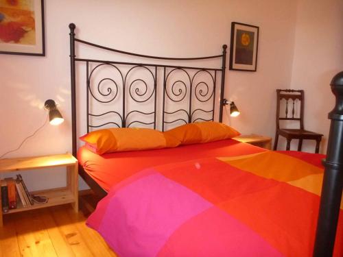 a bedroom with a bed with a colorful blanket at Haus Hollerbusch in Neunburg vorm Wald