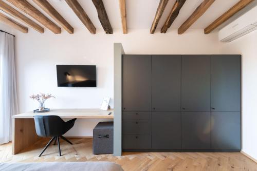 an office with a desk and a large cabinet at TORhaus Appartments Sendenhorst in Sendenhorst