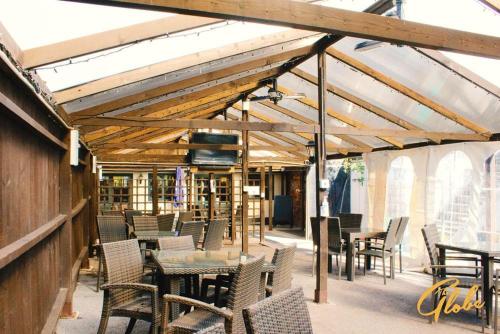 a patio with tables and chairs and a building at The Globe Inn in Tiverton