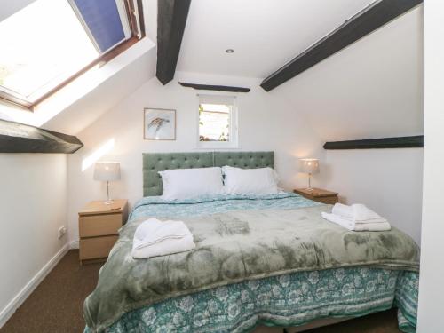 a bedroom with a large bed with two lamps at The Holt in Sidmouth