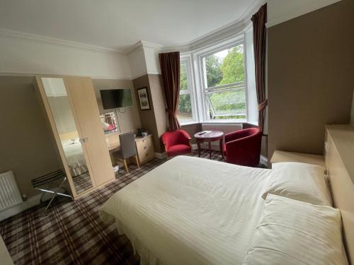 a hotel room with a bed and a window at Mansfield Lodge Hotel Ltd in Mansfield