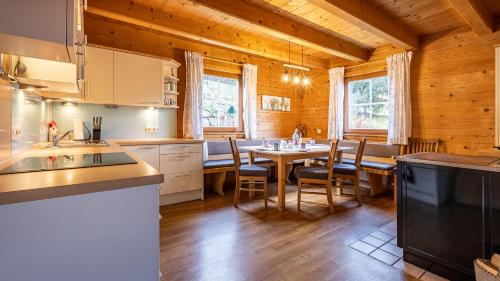 a kitchen with a table and chairs in a cabin at Ferienhaus Untergladner in Schladming
