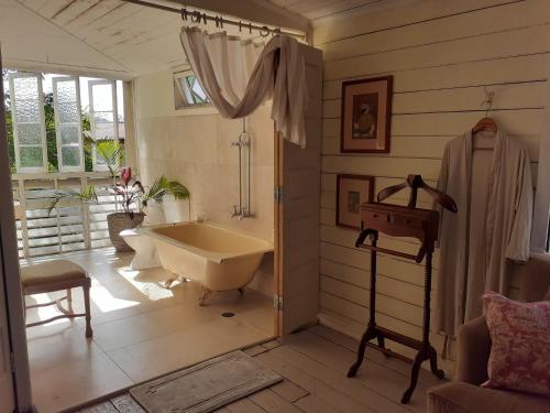 a bathroom with a bath tub and a sink at The Old Bakehouse , Mt Molloy in Mount Molloy