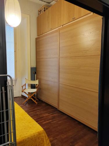 a large wooden closet in a room with a bed at residenza San Martino in Naples
