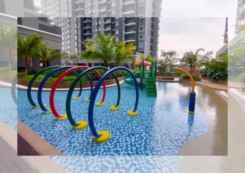a swimming pool with a colorful water slide at Cozy 2R2B Relaxing Skyline Views #GA2 in Shah Alam
