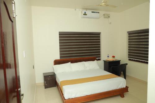 a bedroom with a bed in a room at Athirappilly Ambady Resort in Athirappilly