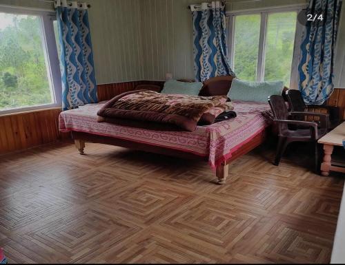 a bedroom with a bed and a wooden floor at Aangan Resort, Bageshwar in Bāgeshwar