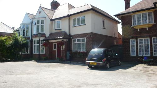 a black car parked in front of a house at Acorn Guest House in Hull in Hull