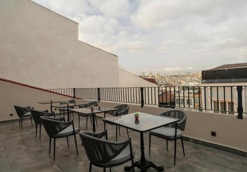 a restaurant with tables and chairs on a balcony at Livro Hotel in Istanbul