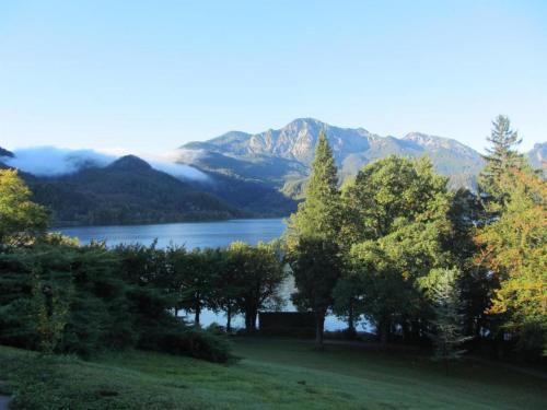 a view of a lake with trees and mountains at Ferienwohnung Heimbeck Kochel in Kochel