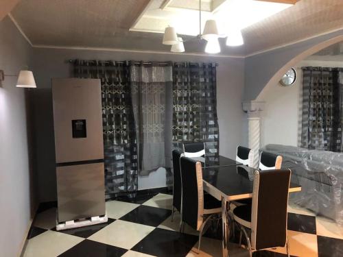 a dining room with a table and chairs at Well presented apartment with 2 master bedrooms. in Freetown