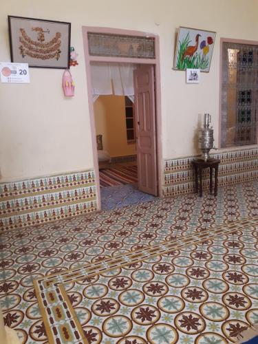 a room with a door and a tile floor at Écologie oasis tafilalt CHEZ L' HABITANT in Er Rachidia