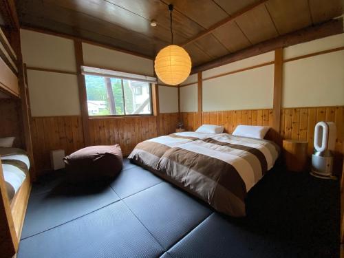 a bedroom with a large bed and a window at Heidi Guest House in Yuzawa