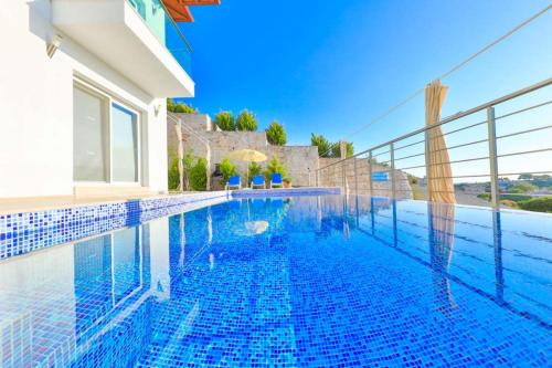 a swimming pool in a villa with blue tiles at James Pansiyon Blue sea view villas Kaş Peninsula in Kas