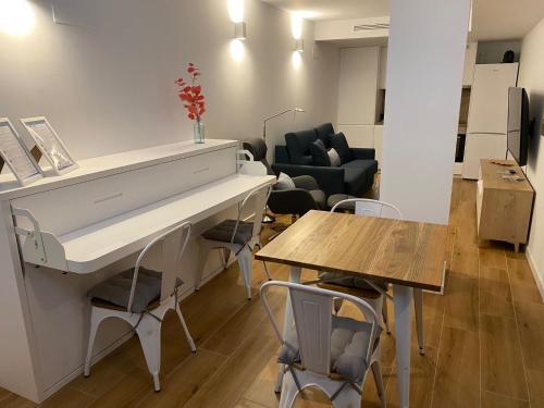 a living room with a white desk and a table at Travel Habitat Alameda Suites. in Valencia