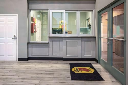a rug on the floor in front of a door at Super 8 by Wyndham North Hollywood in North Hollywood