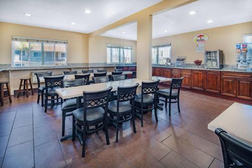 a restaurant with a bar with chairs and tables at Super 8 by Wyndham San Diego Hotel Circle in San Diego