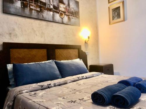 a bed with pillows and pillows on it at Casa Bea B&B in Tortolì
