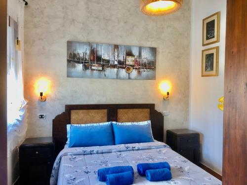 a bedroom with a bed and a painting on the wall at Casa Bea B&B in Tortolì