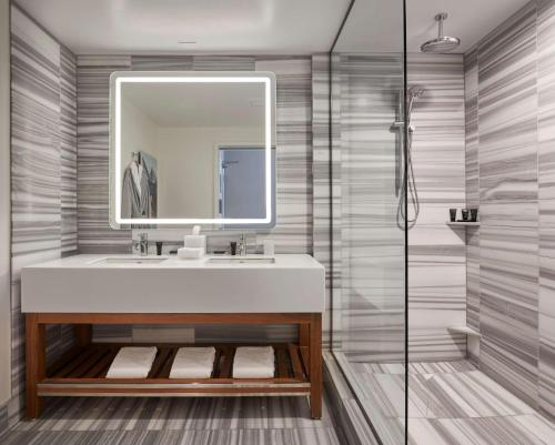 a bathroom with a sink and a mirror at Hyatt Centric the Pike Long Beach in Long Beach