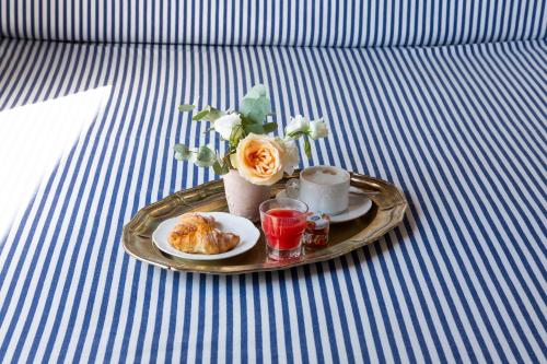 a tray with a plate of food on a table at Aeneas' Landing Resort in Gaeta